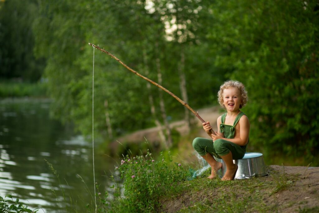 One of the fun camping activities for kids to keep them off their screens is fishing in the lake