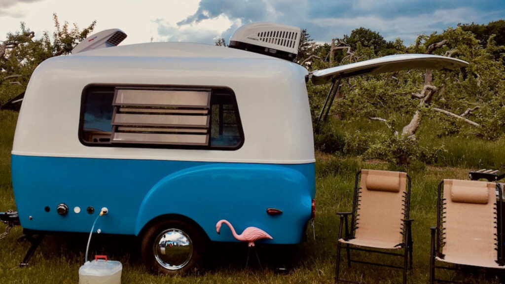 A vintage Happier Camper parked outside 