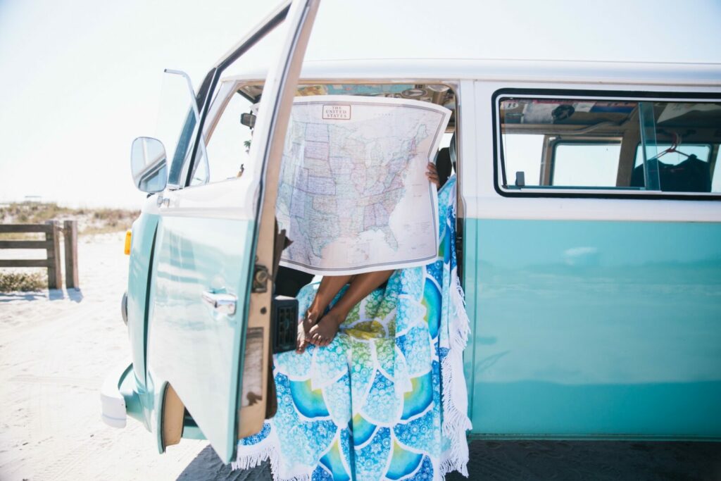 A woman in her vintage camper looking at a map