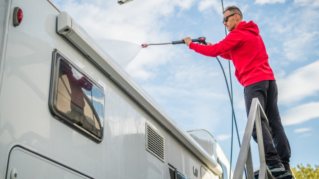 A man using RV cleaner to clean his RV