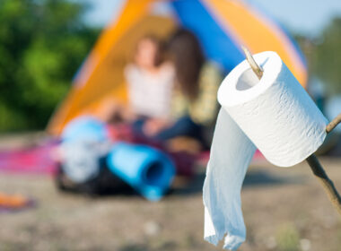 Campers and a thing of toilet paper for their to use with their portable toilet for camping