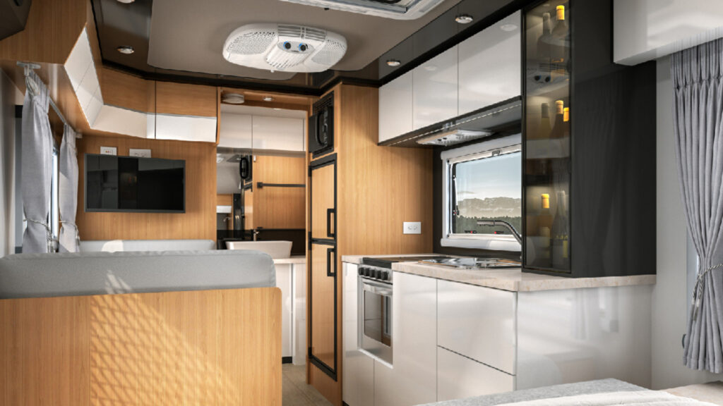 The inside kitchen and living area of a black series camper