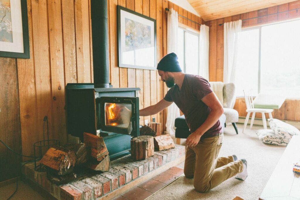 A man using his RV wood stove