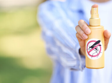 A person holding their mosquito repellent device