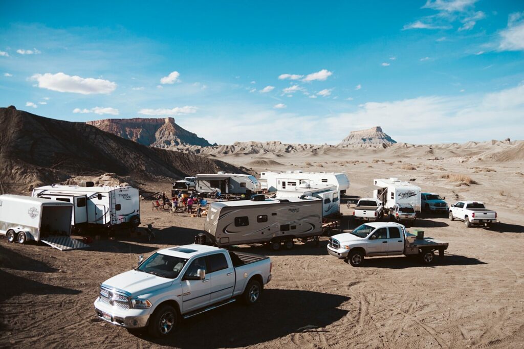 A group of RVs and trucks after being towed, which was done after figuring out how much can my truck tow