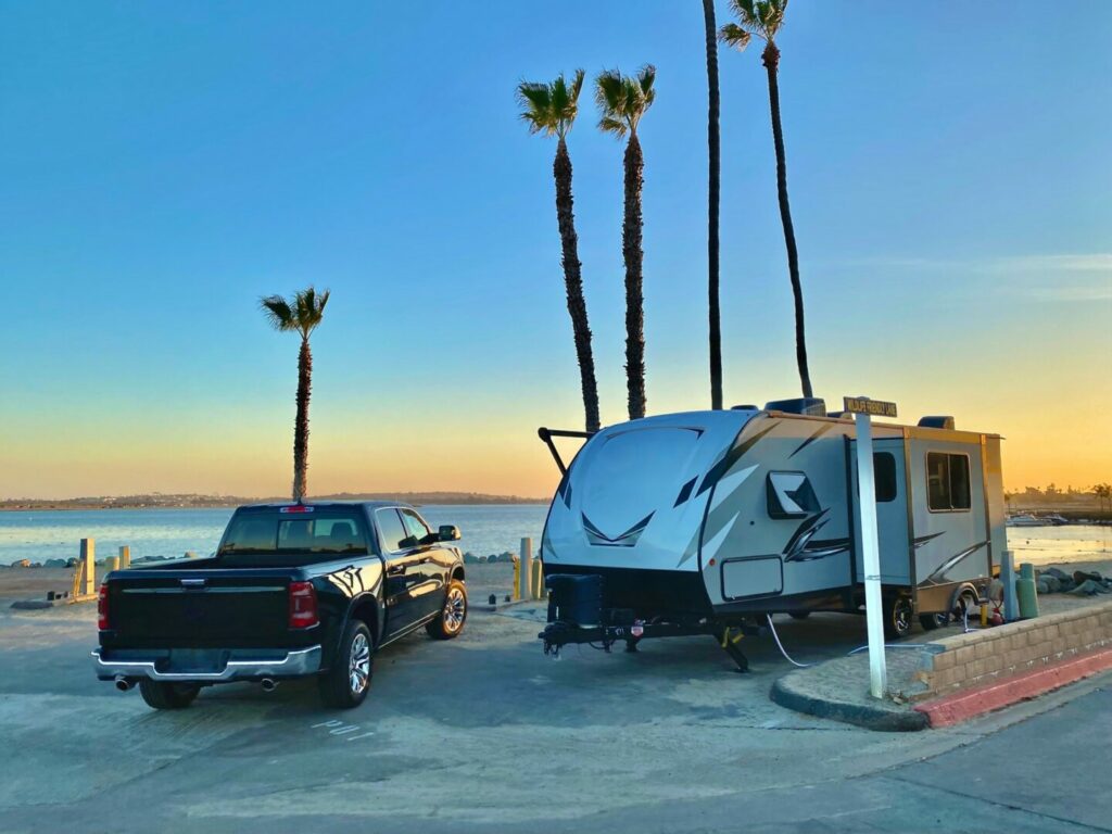 An RV next to a truck trying to decide how much can their truck tow