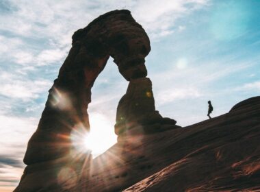 A person walking at Arches National park, during the best time to visit Utah