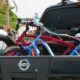 A truck on the road with bikes in the truck bed bike rack