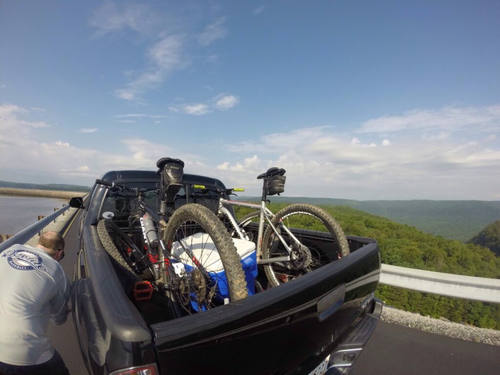 A man getting ready to hit the road with his truck bed bike rack all set up.