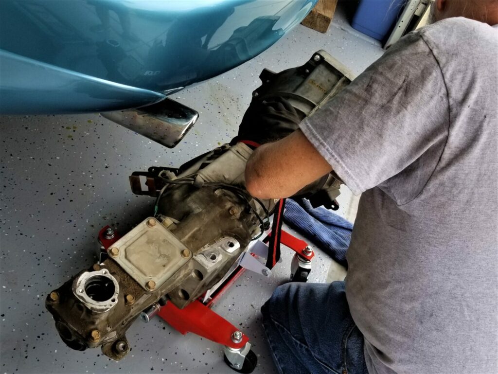 A man working on his transmission