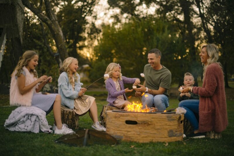 A family camping using their camping fire pit