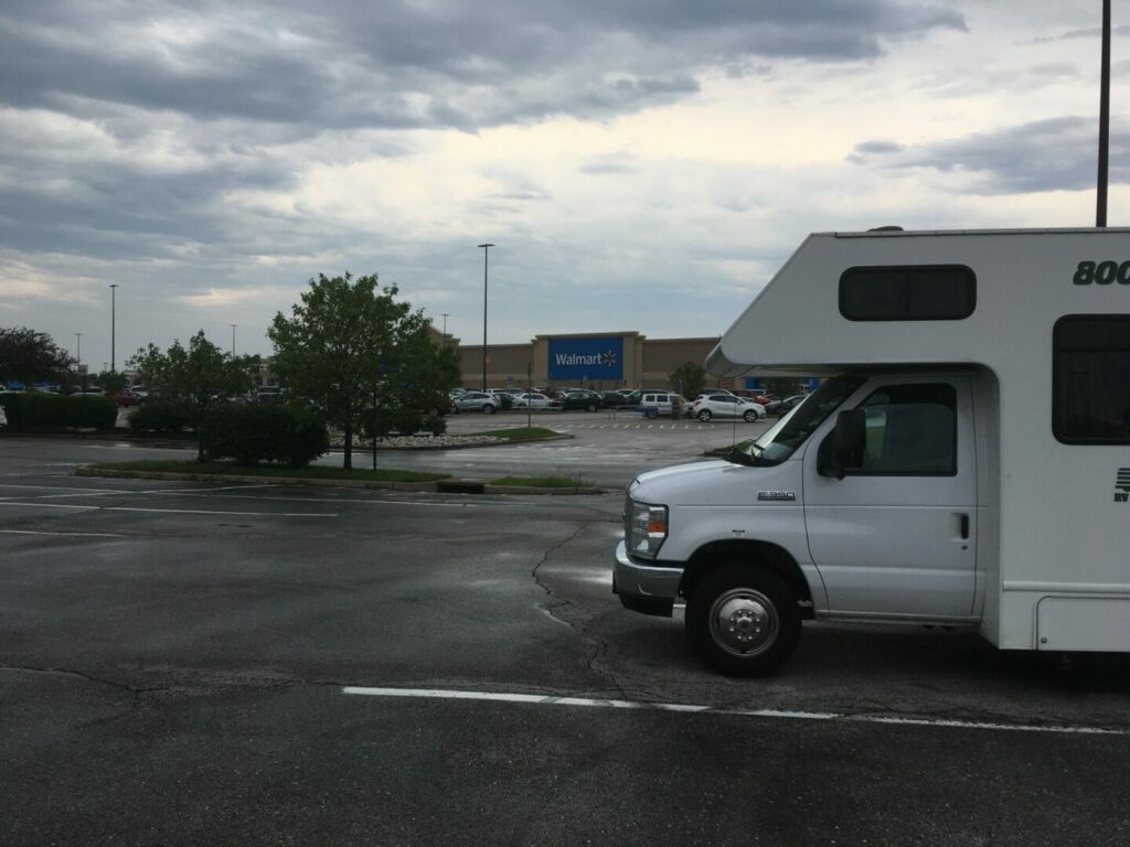 An RV parked in a Walmart parking lot without needing any rv hookups