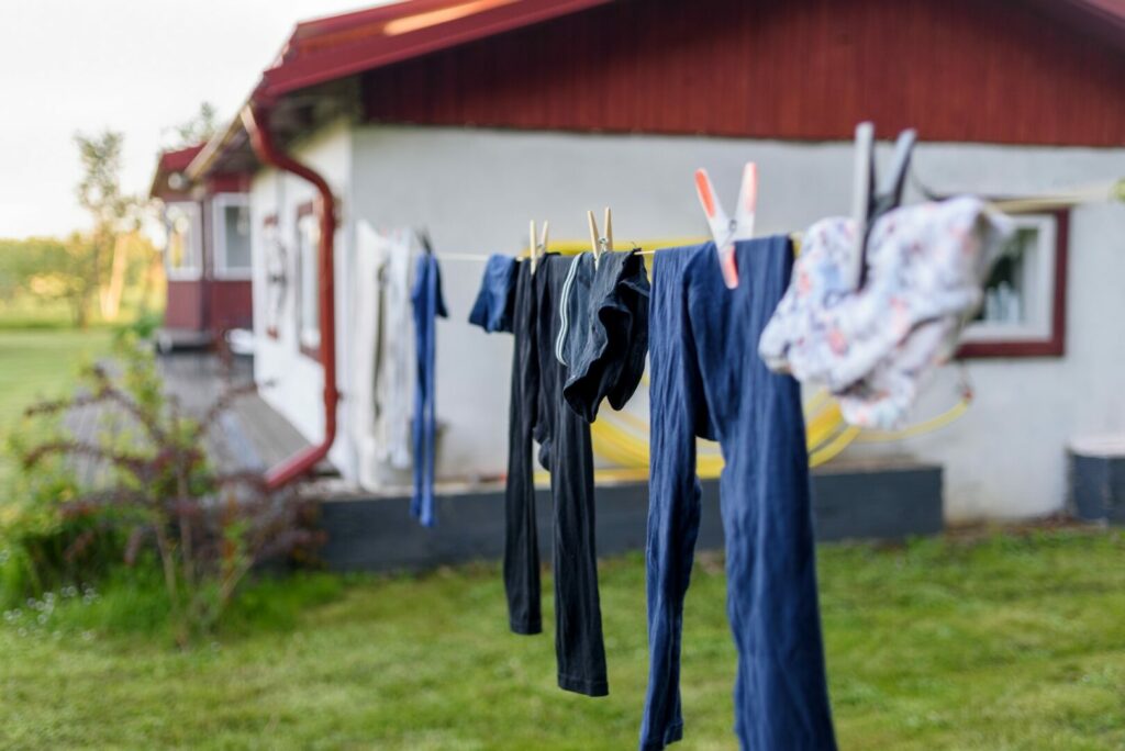 Clothes hanging outside to air dry which is a method on how to get campfire smell out of clothes