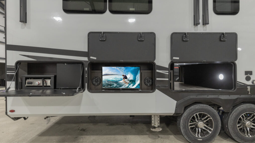 A Grand Design RV toy hauler with an outdoor kitchen