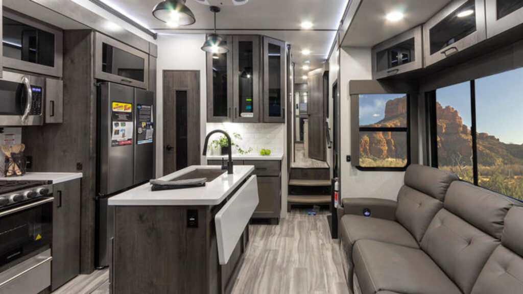 The inside of an Alliance RV with a toy hauler outdoor kitchen