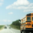 A school bus on the road after figuring out how much does a school bus weighs