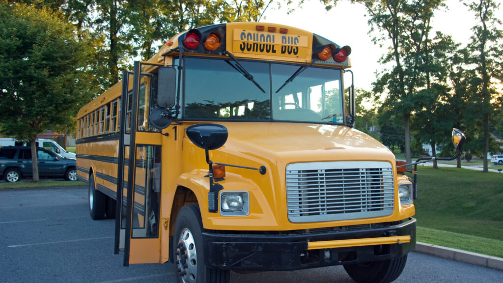 A type C school bus parked after figuring out how much does a school bus weighs