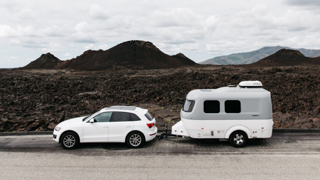An Airstream Nest being towed by an SUV