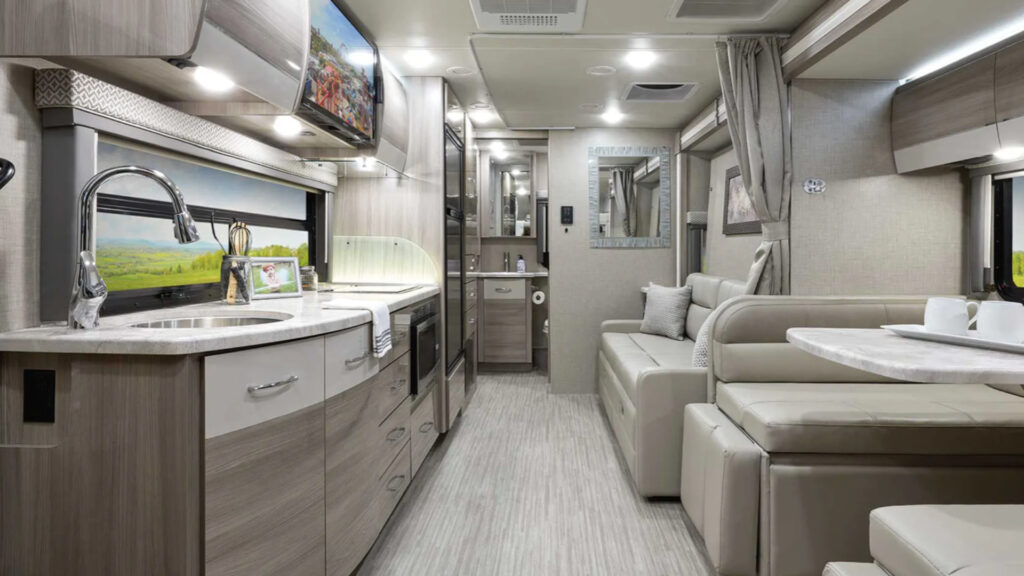 The kitchen and living area inside a Thor Tiburon small class c RV