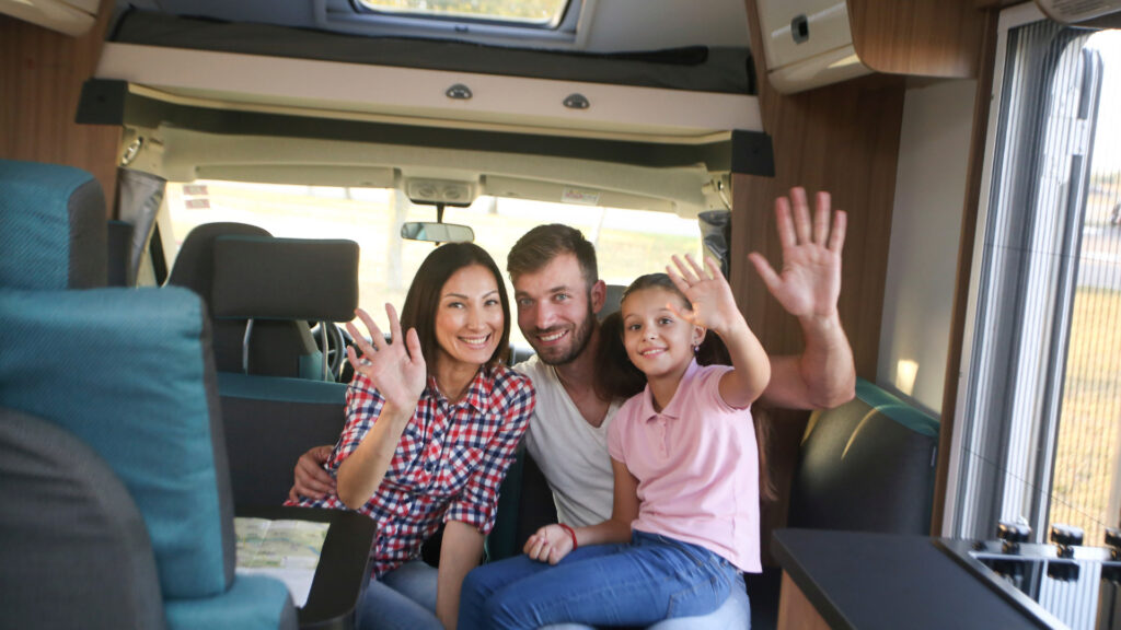 A family waving goodbye after deciding on their RV exit plan