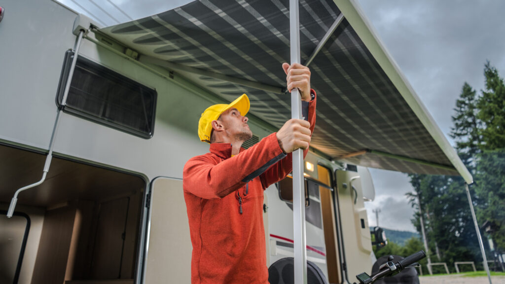 A man setting up his electric rv awning