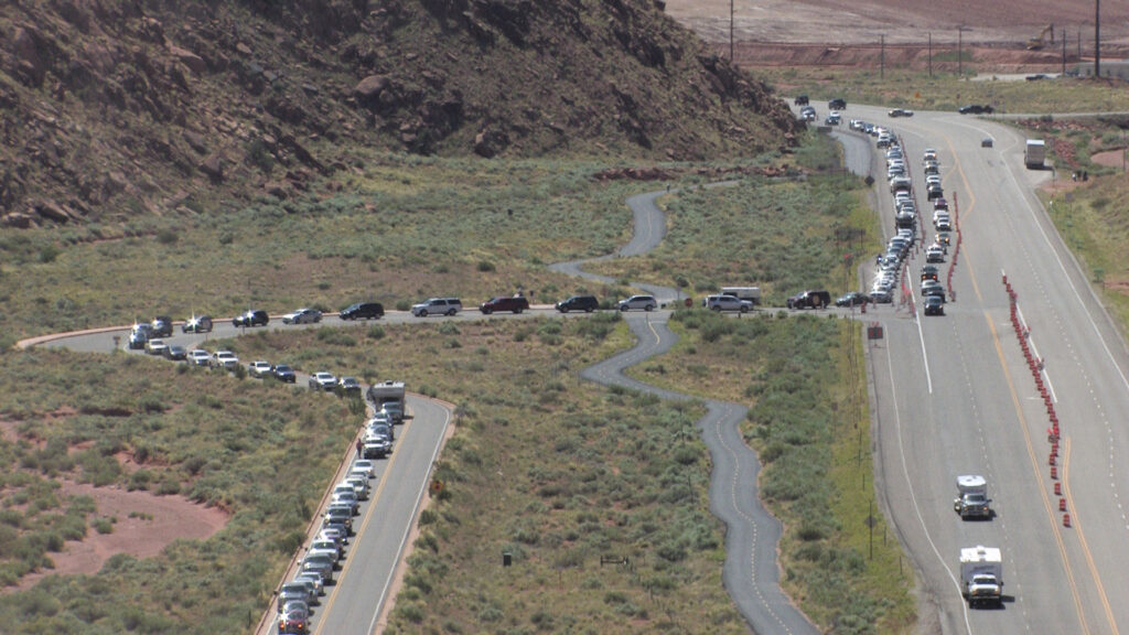 Long line of traffic extending from the entrance to Arches national park
