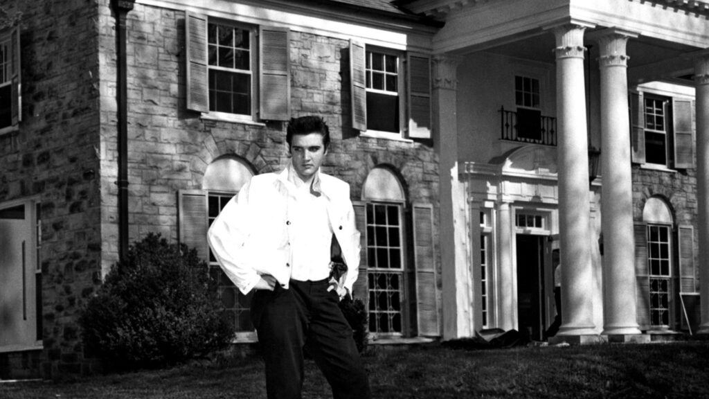 Elvis Presley standing outside his House