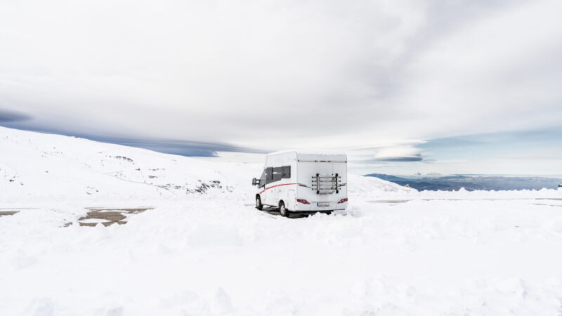 An RV parked in the snow during winter camping