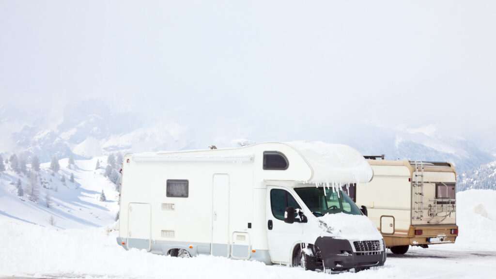 An RV parked in the snow during winter camping