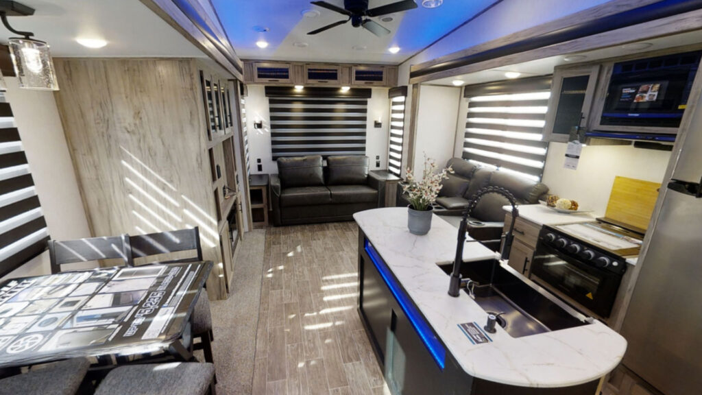 View of the inside living and kitchen area of a Arctic Wolf 3550 Suite, one of the best best cold weather RV