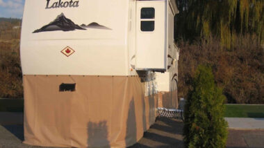 A camper with RV skirting parked outside