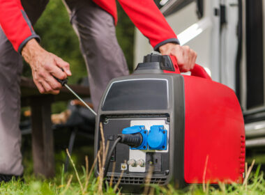 A person setting up their RV generator for their air conditioner