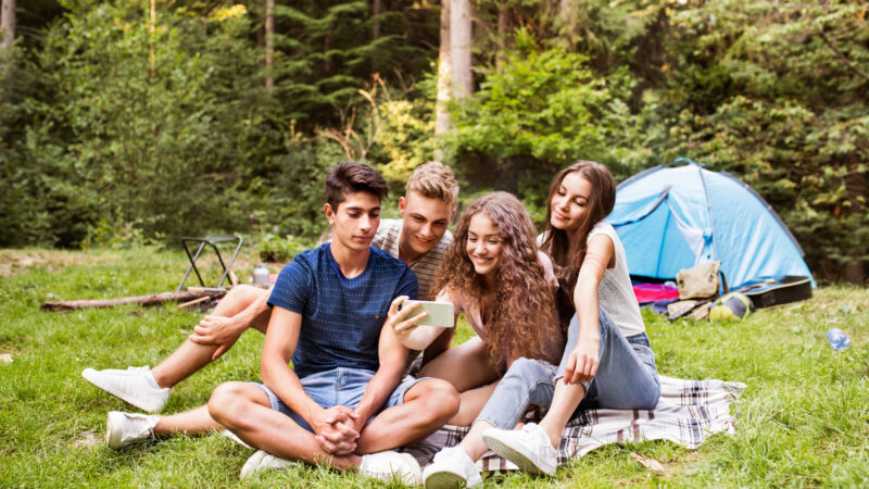 Teens taking a selfie while on a camping trip