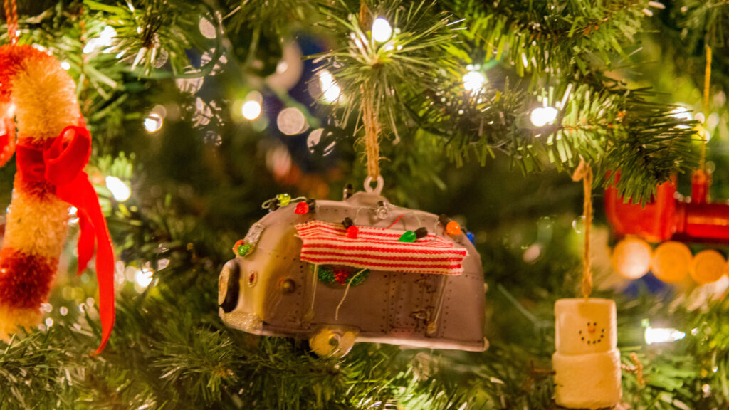 Close up of an RV camping ornament on a tree 