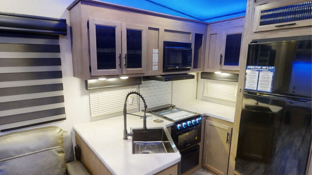 The rear kitchen in aForest River Arctic Wolf 261RK fifth wheel