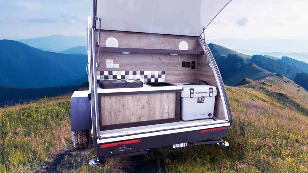 A Bushwhacker camper with a pull-out griddle and sink