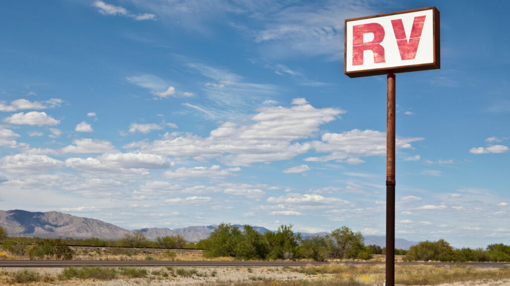 A sign to an RV dealership where you can RV rent to own