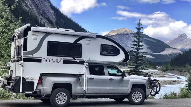 A nuCamp short bed truck camper parked outside