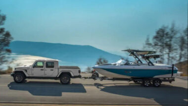 A jeep gladiator towing a boat and testing the towing capacity