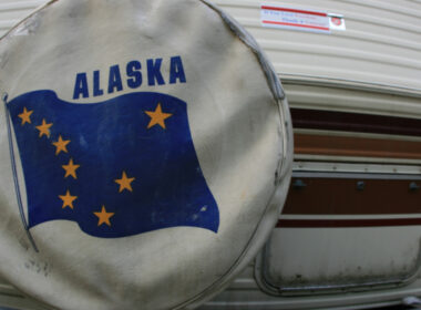 An rv spare tire covers with the Alaska flag on it