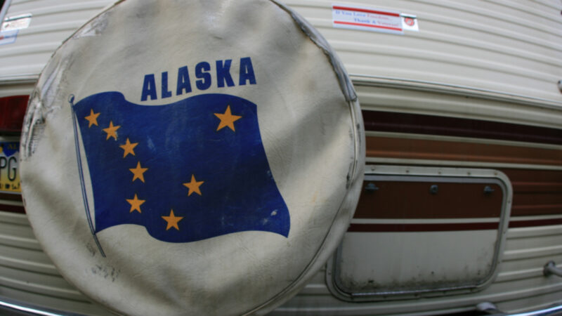 An rv spare tire covers with the Alaska flag on it