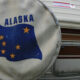 An rv spare tire covers with the Alaska flag on it