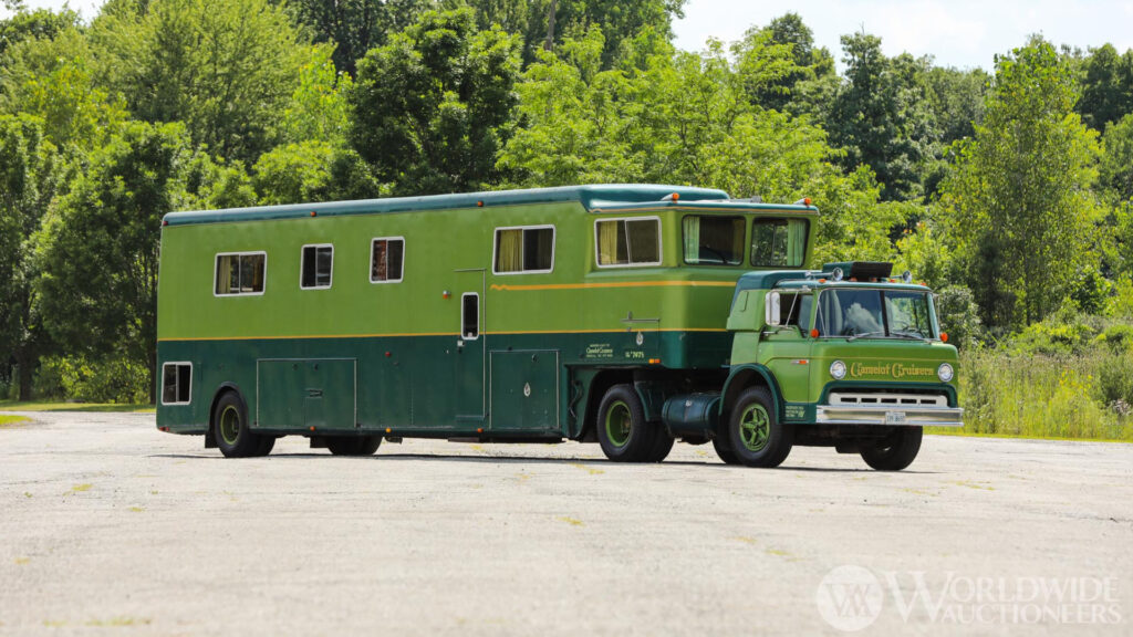A green camelot cruiser parked outside