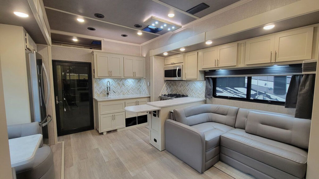 The kitchen and living room area inside a luxe 5th wheel toy hauler