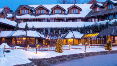 The von trapp family lodge in the winter covered in snow