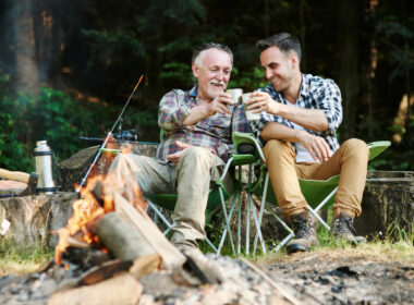 A father and son drinking from mugs from an rv gift guide for dad