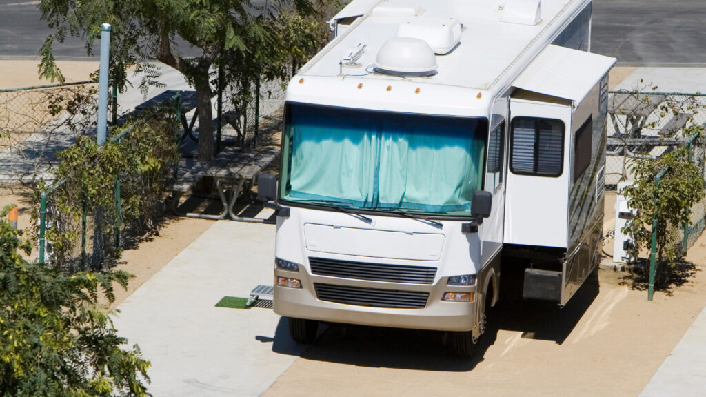 An RV parked that needs to be fixed due to the bottom of the slide bowing out