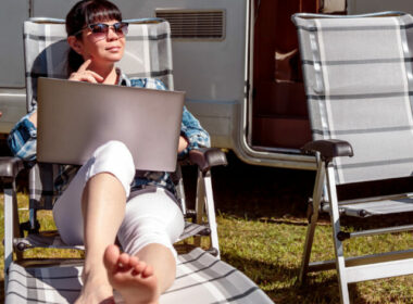 A woman working by her RV, deciding if living in an RV is her retirement dream