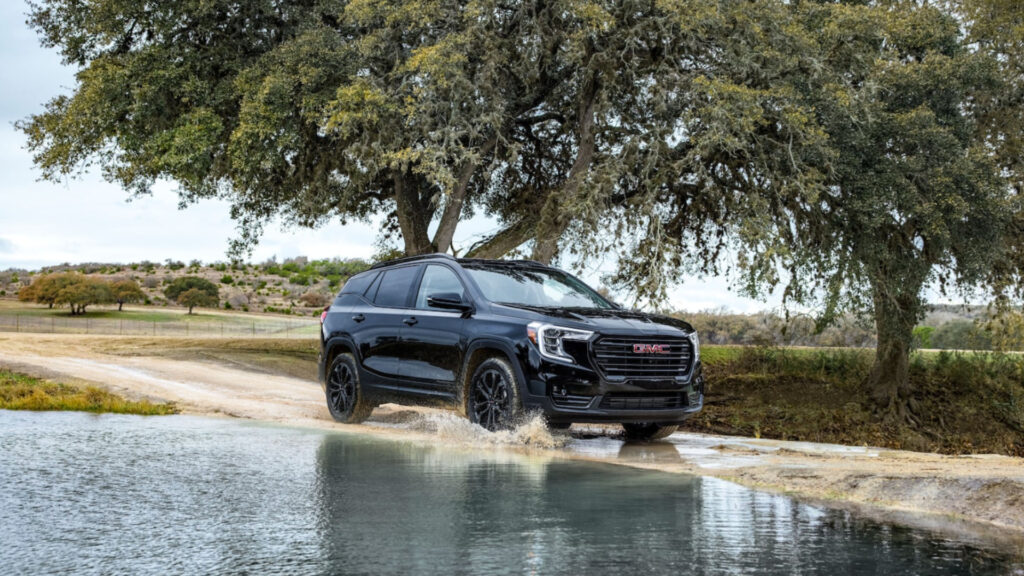 A gmc terrain driving through a muddy road with a poor towing capacity