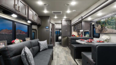 the inside living and driving area of a thor outlaw class a motorhome toy hauler